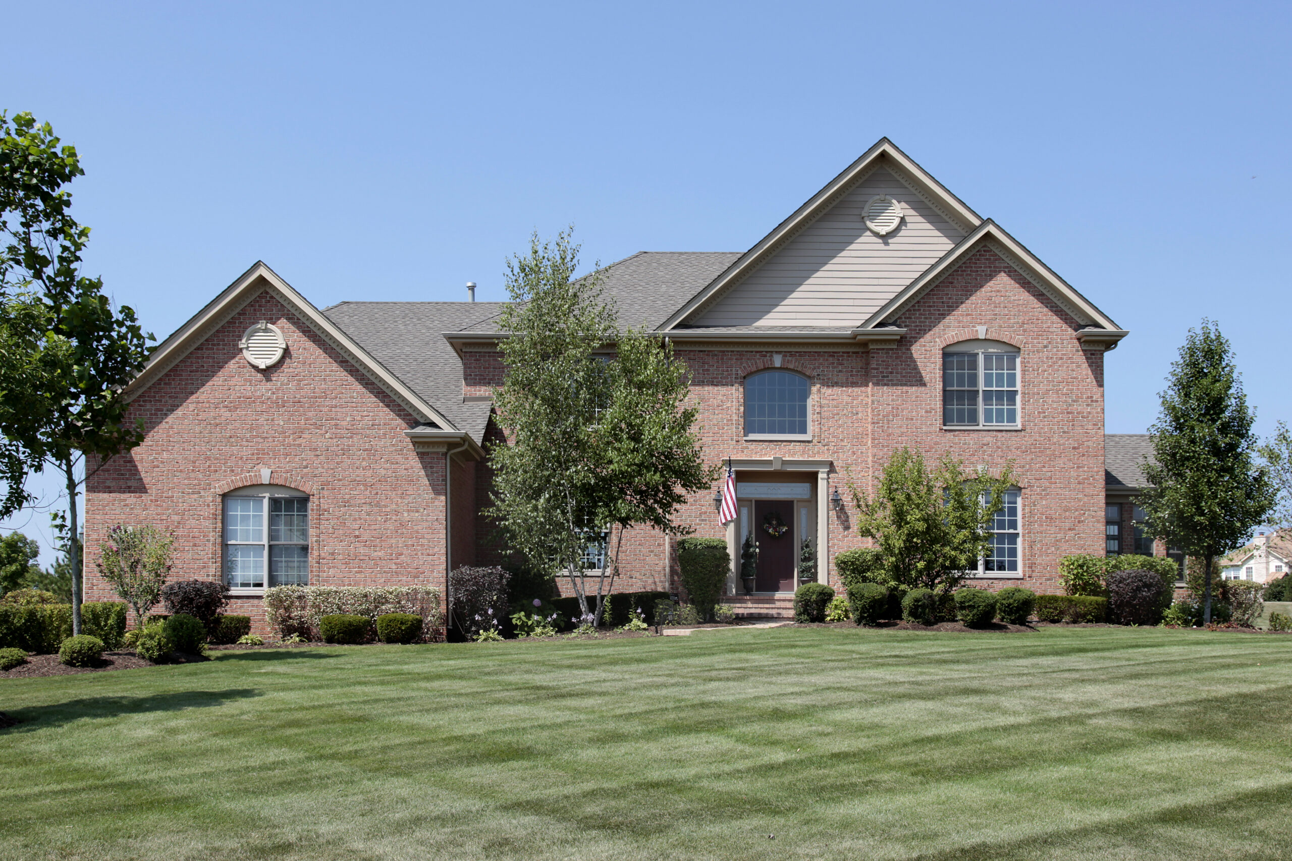 Large,Brick,Home,With,Second,Story,Window